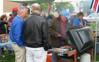 Picture of people grilling burgers